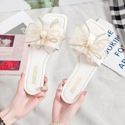 拖鞋女2021夏季新款仙女风蝴蝶结平底一字拖外穿漂亮珍珠沙滩拖鞋卡诺蔻
